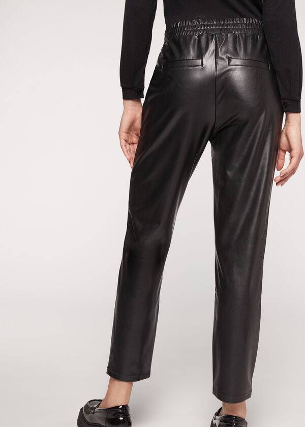 schwarze damen-hose von calzedonia mit thermobeschichtung und kettenbesatz